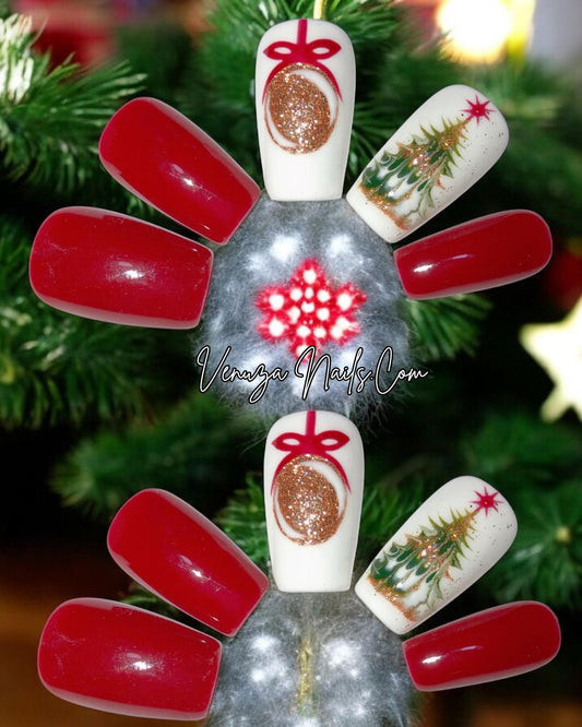 press-on nails rouges et blancs au style Noël. Deux ongles sont rouges brillants, un ongle blanc avec une boule dorée dessinée avec un ruban rouge, et un autre ongle blanc décoré d’un petit sapin de Noël doré et vert. Les capsules sont longues et brillantes, avec une ambiance festive et élégante.