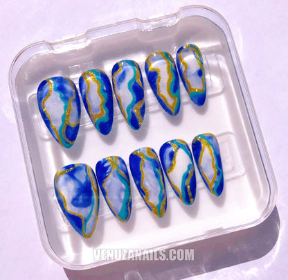 (zoom sur les motifs marbrés) :
alt="Faux ongles effet marbre bleu et doré – manucure élégante avec press-on nails Venuza Nails"